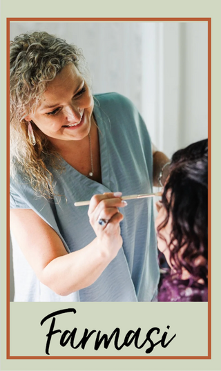 Woman applying makeup to another person with 'Farmasi' branding at the bottom.