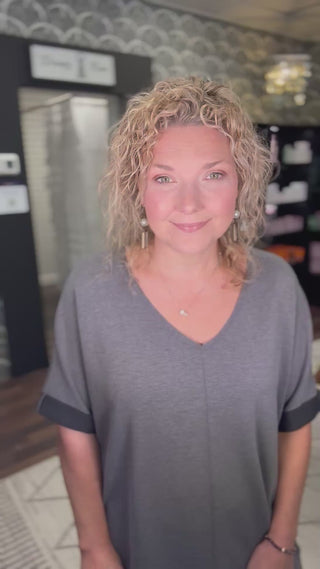 Close-up of V-Neck Dress Charcoal made from soft scuba modal, showcasing the relaxed neckline and smooth texture for all-day comfort.