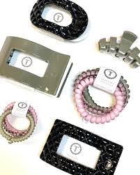 Stylish Teleties hair accessories in pink, gray, and black designs.