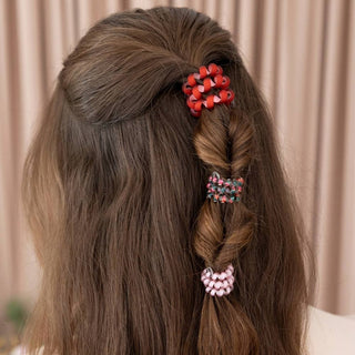 TELETIES hair braid with orange-red and pink coiled hair tie accents