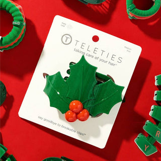 TELETIES brand card displaying green glitter holly leaf flat hair clip with red berries