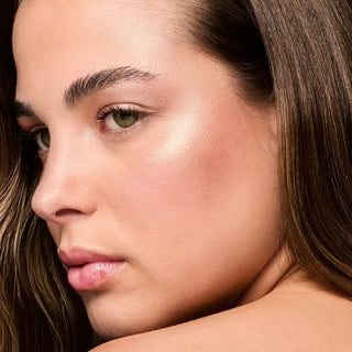 Rose-gold highlighter glow on cheek and nose on fair skin