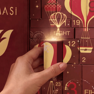 Farmasi beauty advent calendar hands pulling out a small numbered door box
