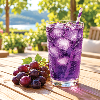 Jordan's Skinny Mixes grape soda syrup bottle with a full glass of purple soda and fresh grapes