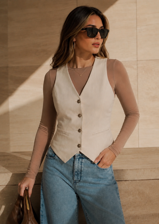 Elietian Seamless Sheer Mesh Top in Toffee layered under a cream vest with jeans