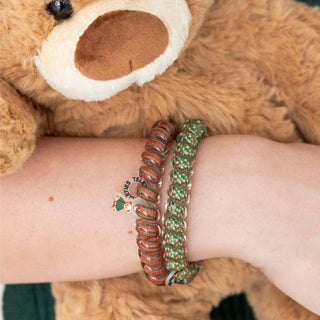 TELETIES hair ties with plaid bands and holiday print on wrist beside a plush bear