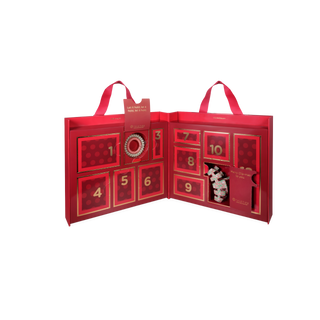 TELETIES red fold-out advent calendar with numbered doors 1–12 and one door showing a gift