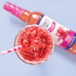 Jordan's Skinny Mixes Shirley Temple soda syrup drink: close-up of cherry soda in a glass with ice bubbles