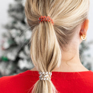 TELETIES red and green beaded hair tie holding a ponytail