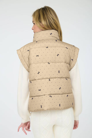 Back view of khaki polka-dot bow print puffer vest with padded yoke