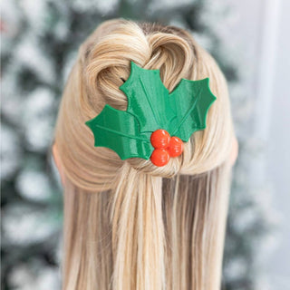 TELETIES holly leaf hair clip on blonde hair, green glitter leaves with red berries