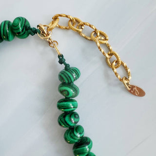 Close-up green beaded necklace with gold-toned chain and lobster clasp