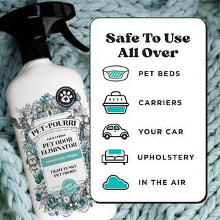Pet odor eliminator spray bottle with black trigger sprayer on knit blanket surface