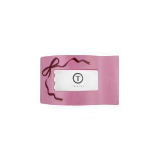 Pink flat rectangle hair clip with back label window and TELETIES logo