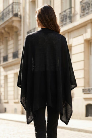 Dear Scarlett cozy sweater knit poncho shown in black, back view