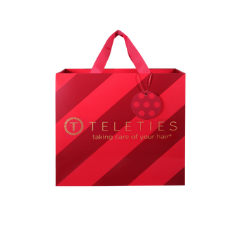 Red holiday advent calendar gift bag with ribbon handles and TELETIES logo