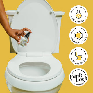 Trigger toilet spray bottle being sprayed near an open toilet bowl