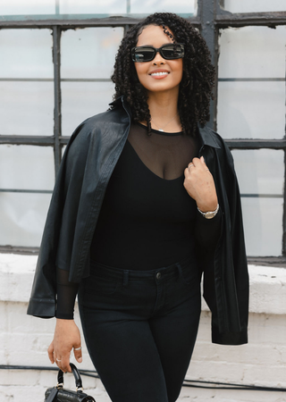 Elietian Seamless Sheer Mesh Top in Black under a leather jacket, front view