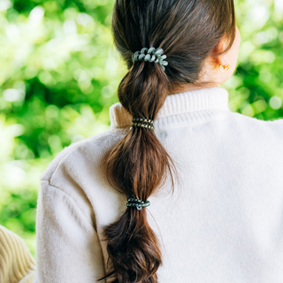 Teleties mixed spiral hair ties in Mossy Moments olive and sage green, shown in hair