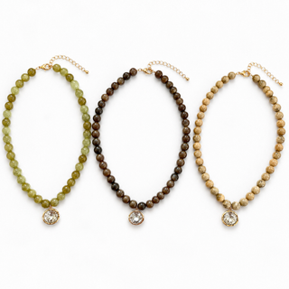 Olive marbled bead necklace with round crystal pendant in gold-tone setting