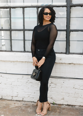 Elietian Seamless Sheer Mesh Top in Black with black jeans and a handbag, full-length view