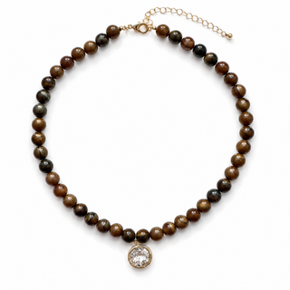 Dark brown bead necklace with oval crystal pendant and gold-tone extender chain