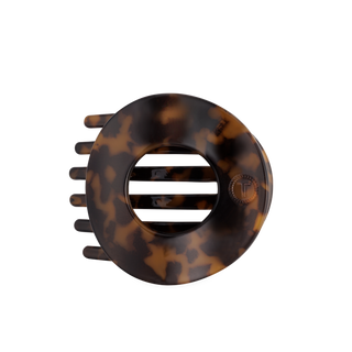 Flat circle hair clip, tortoise shell print, metal bar center and visible prongs