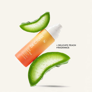 Glow face mist bottle with orange label and white mist cap; shown with aloe leaf