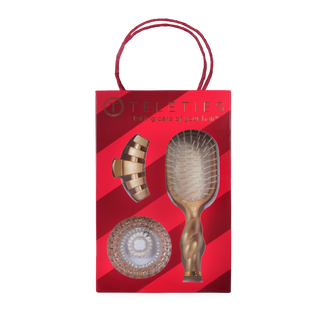 TELETIES Holiday Brush Gift Set in a red striped gift box with gold-toned hair brush and claw clip