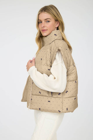 Khaki polka-dot bow print puffer vest side view with zip closure