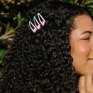 TELETIES Aquaviolet snap clips worn in dark curly hair