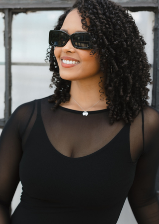 Elietian Seamless Sheer Mesh Top in Black over a black tank, close-up with sunglasses
