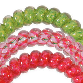 TELETIES close-up of red, pink, and green coiled hair ties with plaid accents