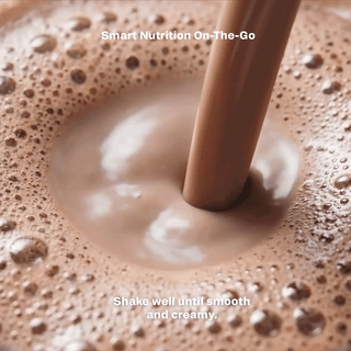 Glass with velvet chocolate shake and frothy bubbles, ready to sip