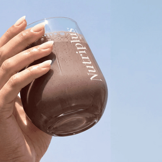 NutriPlus velvet chocolate shake bottle held in hand with screw-top lid