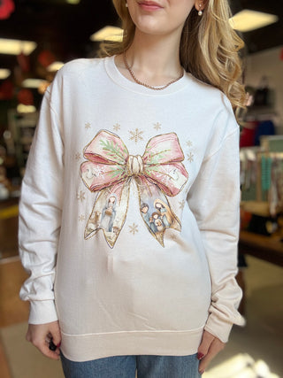 Dash Forward Christmas Bow Nativity Sweatshirt in sand on a model, front view