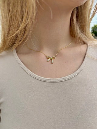 Gold bow charm with crystal detail, delicate necklace pendant
