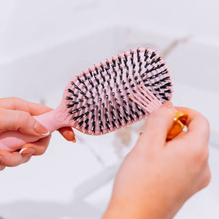 TELETIES bubblegum pink handheld boar bristle hair brush close-up, bristles facing