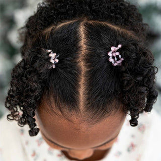 TELETIES two small pink spiral hair ties securing curly hair, side view
