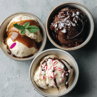 Jordan's Skinny Mixes holiday drizzle sauce trio on three ice cream bowls: caramel, mocha and dark chocolate