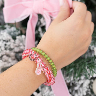 Small hair tie bracelet on wrist, red and green beads