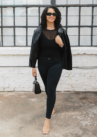 Elietian Seamless Sheer Mesh Top in Black under a leather jacket with black jeans