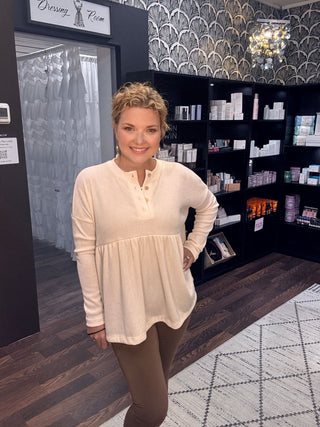 Effortless style babydoll top in cozy beige fabric, featuring a relaxed fit and button detail, ideal for casual fall fashion.