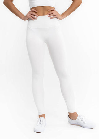 High-waist crossover leggings in white, full-length skinny fit.