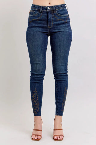 Plus Size High Rise Embroidered Skinny Jeans by Judy Blue featuring dark wash denim and intricate embroidery on lower legs, ideal for curvy figures.