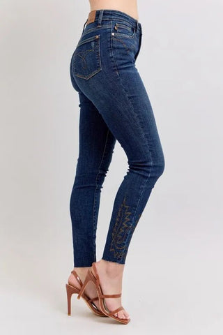 Side view of Judy Blue Plus Size High Rise Embroidered Skinny Jeans showcasing flattering fit and detailed embroidery near the ankle.
