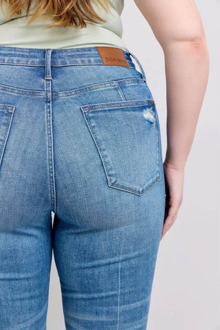 Close-up of back waistband and pockets on Judy Blue Vintage Wash Boot Jeans featuring leather brand patch and light distressing.