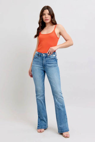 Full body view of model wearing Judy Blue Tummy Control Boot Jeans styled with an orange tank top for a casual chic look.
