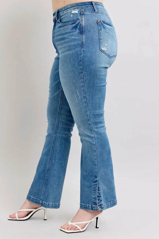 Side angle of plus-size model in Judy Blue HW Boot Jeans with side slit and tummy control for stylish comfort.
