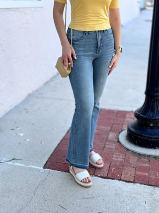Mid Rise Tummy Control Slim Bootcut Jeans with Release Hem Judy Blue – Medium Wash – model photo